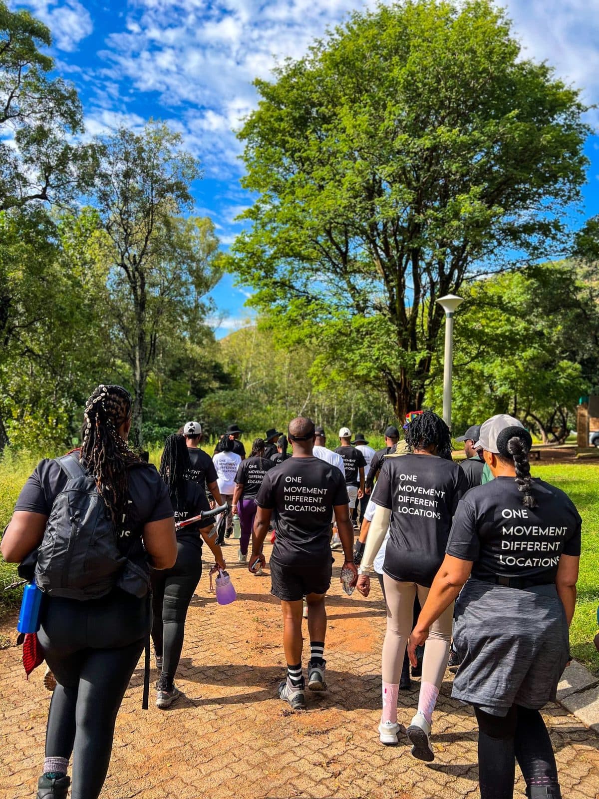 Club members in One Movement Different Locations shirts walking together